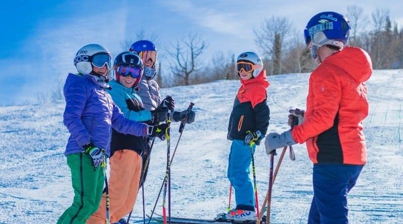 Group of people taking ski lesson